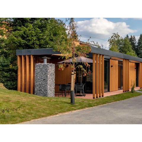 Children's cottage with slide and sun shower, in a holiday park, 100 m piste